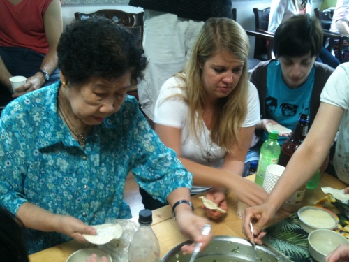 Guests help make mandu with halmoni at the House of Sharing on a previous visit. (House of Sharing)
