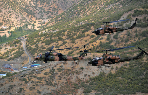 Turkish military helicopters fly over Hakkari province near the border with Iraq on Saturday. (AP-Yonhap News)