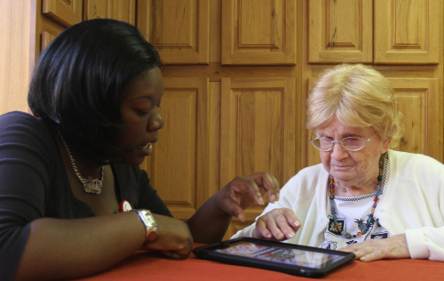 Recreational Therapy Assistant Felicia Johnson plays “The Price is Right” with Esther Nelson on an iPad at Health Central Park long-term care facility in Winter Garden, Florida, Sept. 21. (Orlando Sentinel/MCT)