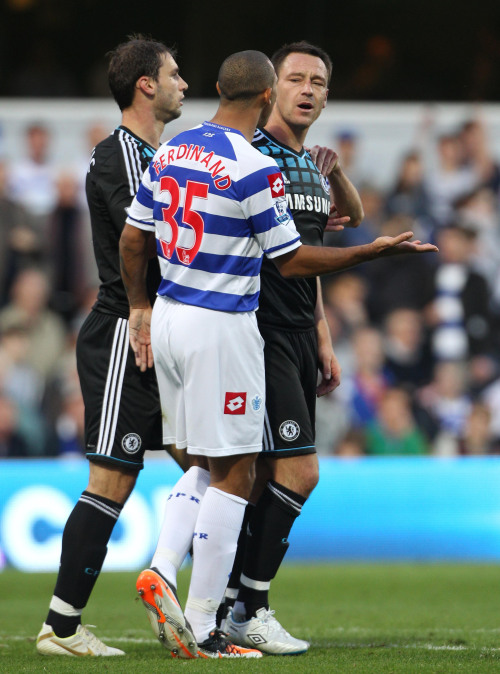 Chelsea captain John Terry (right) speaks with QPR’s Anton Ferdinand during their Premier League match on Sunday. (AP-Yonhap News)
