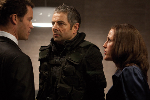 Agent Ambrose (Dominic West, left), Johnny English (Rowan Atkinson, center) and Director Thornton (Gillian Anderson) in the comedy/spy thriller, “Johnny English Reborn.” In the film, Atkinson returns to the role of the improbable secret agent who doesn’t know fear or danger. (Giles Keyte/Courtesy Universal Pictures/MCT)