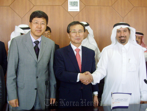 Daelim Industrial Co.’s chief of industrial plant operations Kim Yun (center) shakes hands with Saudi Arabia’s Deputy Minister for Electricity Saleh Alawji (right) after signing the contract in Riyadh on Saturday. (Daelim Industrial)