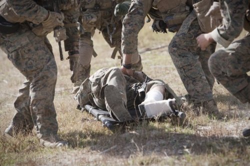 A US Marine suffering from fractures in his leg is carried by his comrades to a medevac helicopter in Helmand province in October 2011. (AFP)