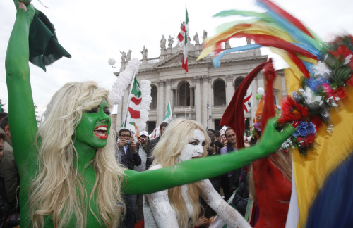 Ukrainian women`s rights group Femen, painted in colors of the Italian flag, shout slogans against Italian Premier Sivlio Berlusconi during a demonstration staged by the Italian Democratic party in Rome Saturday. (AP-Yonhap News)