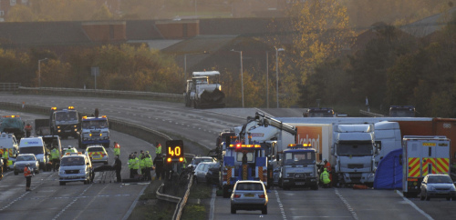 A general view of the scene on the M5 motorway close to Taunton in southwestern England, Saturday Nov. 5, 2011 following a 27 vehicle pile-up late Friday, in which at least 7 people were killed and dozens of others injured. Around 27 vehicles, including a number of articulated lorries, were involved in the devastating crash, described by emergency workers as 'the worst road traffic collision anyone can remember' in the area. (AP-Yonhap News)