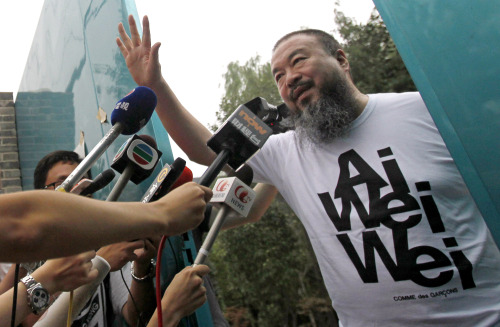 In this June 23, 2011 file photo, activist artist Ai Weiwei opens the gate to talk to journalists gathered outside his home in Beijing. Ai said on Monday thousands of supporters have donated more than $550,000 to help him pay off a tax bill sought by the government. A state-run newspaper has warned the movement could be illegal. (AP-Yonhap News)