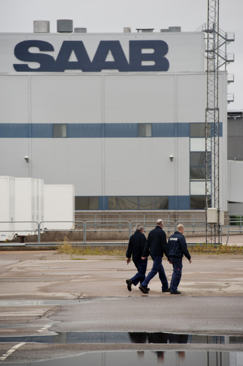 Employees walk through the grounds of the Saab Automobile factory in Trollhaettan, Sweden. (Bloomberg)