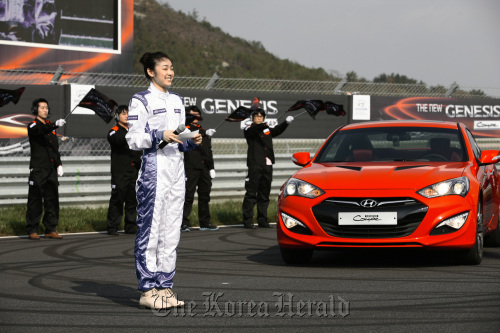 Olympic figure skating gold medalist Kim Yu-na introduces the New Genesis Coupe of Hyundai Motor at the launch of the sports sedan in Yeongam, South Jeolla Province, on Saturday. (Hyundai Motor)