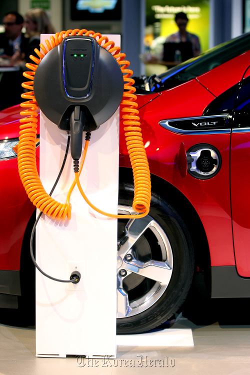 The plug for the General Motors Co. Chevrolet Volt electric vehicle sits on display at New York International Auto Show. (Bloomberg)