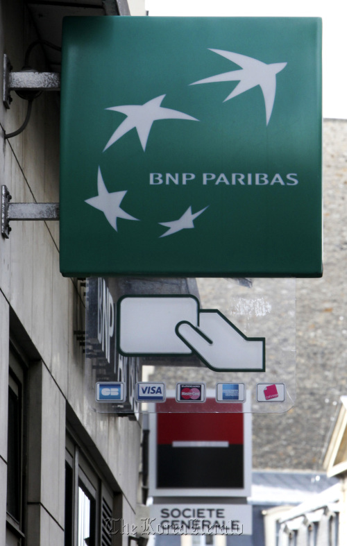 A BNP Paribas SA sign hangs near one for Societe Generale SA in Paris. (Bloomberg)