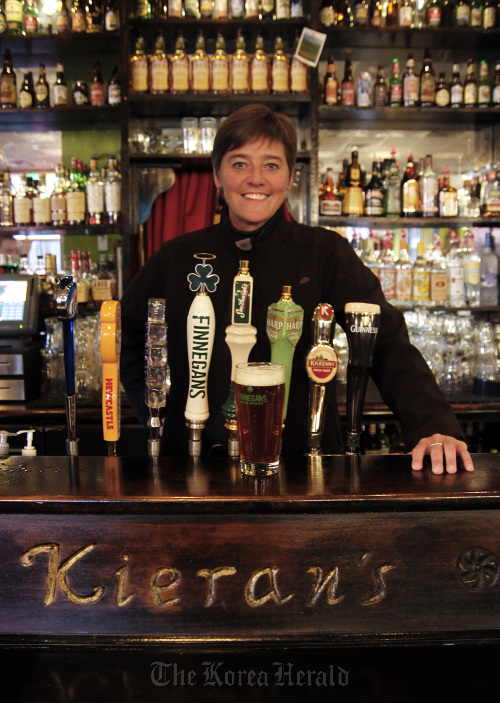 Jacquie Berglund stands behind the bar Nov. 22 at Kieran’s Irish Pub in downtown Minneapolis, which holds the record for selling the most Finnegans. Berglund is founder of the “spud society,” which sells Finnegans beer, giving 100 percent of the profits to charity. (Minneapolis Star Tribune/MCT)