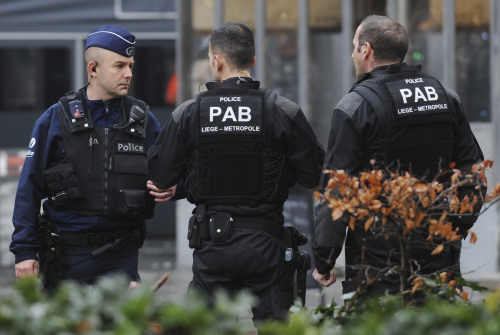 Police officers guard the street, following a grenade attack in the city center of Liege, Belgium, Tuesday, Dec. 13, 2011. It is reported that an unidentified man threw up to four live hand grenades at a bus stop, killing the man and others, and wounding many other people in the crowded square. (AP-Yonhap News)