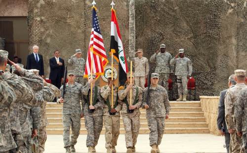 U.S. Defense Secretary Leon Panetta (rear, second from left) attends a symbolic flag-lowering ceremony marking the end of U.S. forces’ mission in Iraq at a U.S. army base west of Baghdad on Thursday. (AFP-Yonhap News)