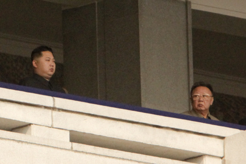 Kim Jong Il, leader of North Korea, left, looks towards his son Kim Jong Un, during a military parade commemorating the 65th anniversary of founding of the Workers` Party of Korea in Pyongyang, North Korea, on Sunday, Oct. 10, 2010. (Bloomberg)