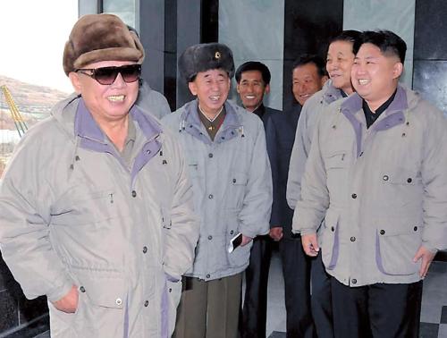 Kim Jong-il and his son Jong-un (right) visit a factory for field inspection in an undated photo released by the North Korean Central News Agency on Nov. 25, this year.