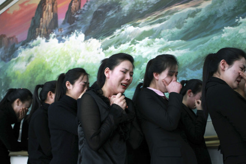 In this photo released by China's Xinhua news agency, North Koreans living in China mourn the death of their leader Kim Jong Il at North Korean Embassy in Beijing, China, Tuesday, Dec. 20, 2011. (AP-Yonhap News)