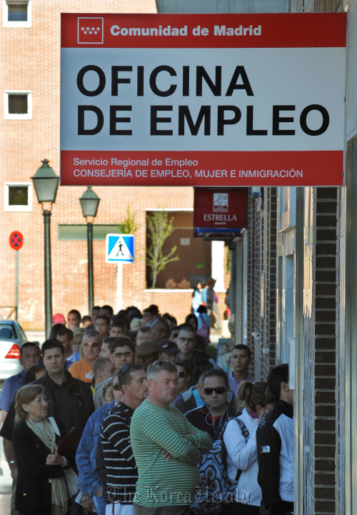 Jobseekers line up at an employment office in Madrid, (Bloomberg)