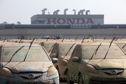 Flood-damaged Honda Motor Co. vehicles are parked at the Honda automobile plant in the Rojana Industrial Park in Ayutthaya, Thailand. (Bloomberg)