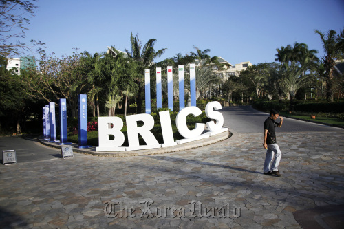 A man walks past a BRICS sign ahead of the summitt in Sanya, Hainan Province, China. (Bloomberg)