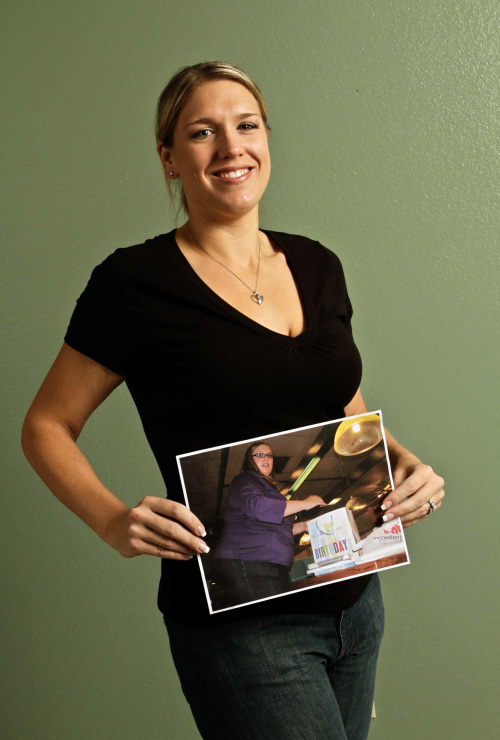 Nicole Neimeyer, of Riverside, California, holding a picture of herself, joined Weight Watchers in March 2009 and began to reshape not only her own health but that of her family. (Los Angeles Times-MCT)
