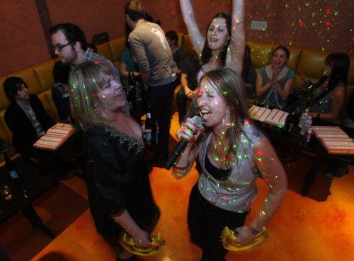 People sing karaoke with friends at Rosen Music Studio, a karaoke/bar/restaurant in Los Angeles in 2010. (Lawrence K. Ho/Los Angeles Times/MCT)