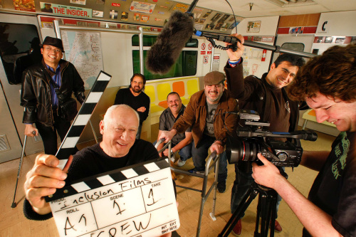 Joey Travolta, foreground left, founder of Inclusions Films in Burbank, is photographed with his students last month, on a set built by the students for a short film production called, “Love on a Train.” (Mel Melcon/Los Angeles Times/MCT)
