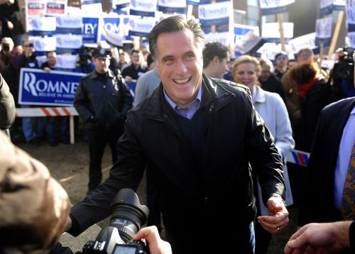 Republican presidential hopeful Mitt Romney greets voters outside a polling station at Webster School in Manchester, New Hampshire, January 10, 2012. (AFP)