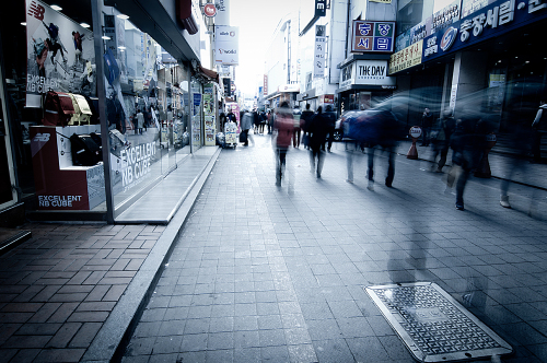 Shoppers walk along a shopping district in Gwangju. (Joe Wabe)