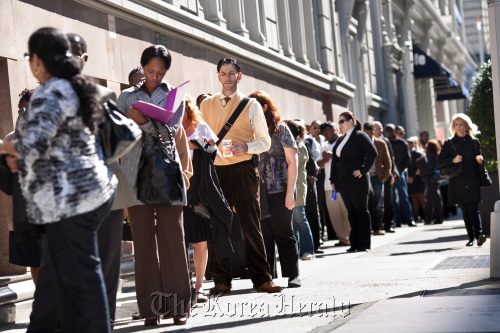 Job seekers wait on line outside the Metropolitan Pavilion before the start of a job fair in New York. (Bloomberg)