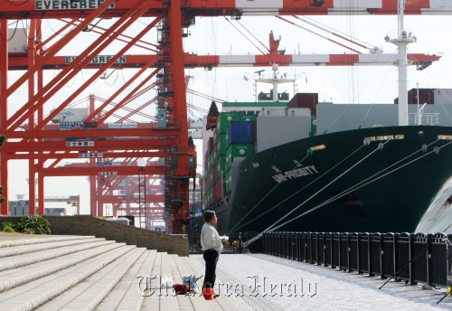 A man stands at a shipping terminal in Tokyo. (Bloomberg)