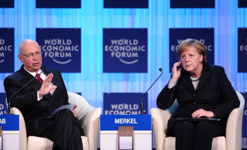 German Chancellor Angela Merkel and WEF founder and executive chairman Klaus Schwab speak during the opening ceremony of the World Economic Forum, in the congress center of the Swiss resort of Davos on Wednesday. (AFP-Yonhap News)