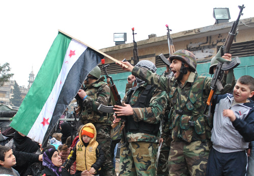 Syrian army defectors shout shortly after joining anti-regime protesters in Homs province on Thursday. (AP-Yonhap News)