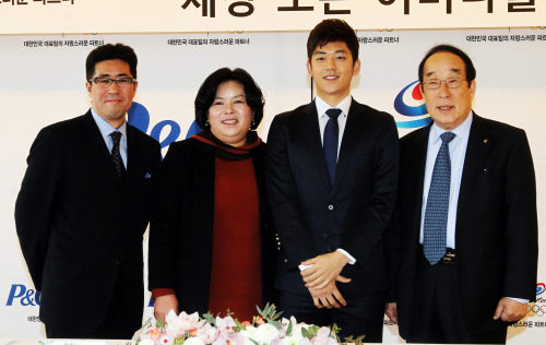 Korean badminton star Lee Yong-dae (second from right) poses with KOC president Park Yong-sung (right), P&G Korea president Shinji Okuyama (left) and his mother, Lee Ae-ja, after signing a sponsorship deal with P&G Korea on Monday in Seoul. (P&G Korea)