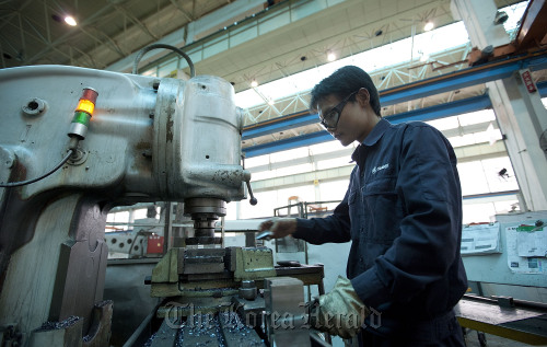 A Sany Heavy Industry Co. worker machines parts at the factory in Changsha, Hunan Province, China. (Bloomberg)