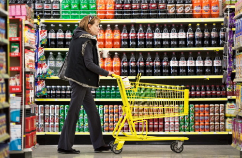 Customer Wendy Rosen pushes a shopping cart past a display of soft drinks at a Dollar General Corp. store in Saddle Brook, New Jersey, U.S. (Bloomberg)