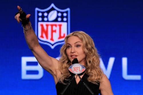 Singer Madonna gestures as she speaks at the podium during a press conference for the Bridgestone Super Bowl XLVI halftime show at the Super Bowl XLVI Media Center in the J.W. Marriott Indianapolis on February 2, 2012 in Indianapolis, Indiana. (AFP)