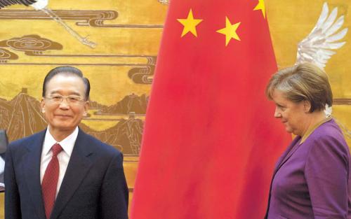 German Chancellor Angel Merkel (right) arrives to address a press conference after meeting with Chinese Premier Wen Jiabao at the Great Hall of the People in Beijing on Thursday. (AP-Yonhap News)