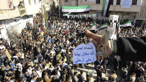 A demonstrator holds up a toy reading 