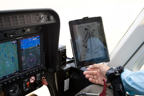 A helicopter pilot looks at his flight plan on an Apple Inc. ipad over Weehawken, New Jersey, U.S. (Bloomberg)