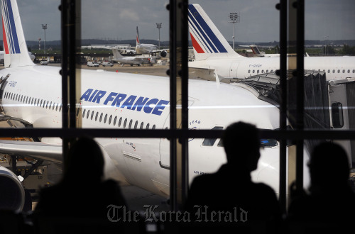 Passengers wait to board Air France flights at Orly Airport in Paris. (Bloomberg)