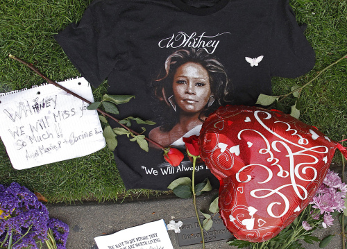 A T-shirt, flowers and notes are left at a makeshift memorial for Whitney Houston outside the Beverly Hills Hilton Hotel in Beverly Hills, California on Monday. (AP)