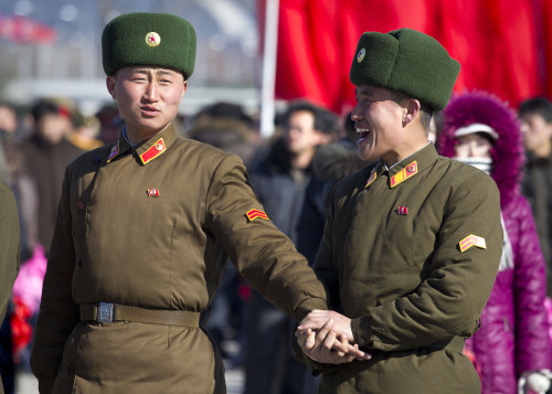 North Korean soldiers share a laugh at Kumsusan Memorial Palace in Pyongyang before a parade commemorating the 70th birthday of the late Kim Jong Il. (AP)