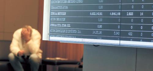 Electronic screens display stock prices inside the Greek stock exchange in Athens. (Bloomberg)