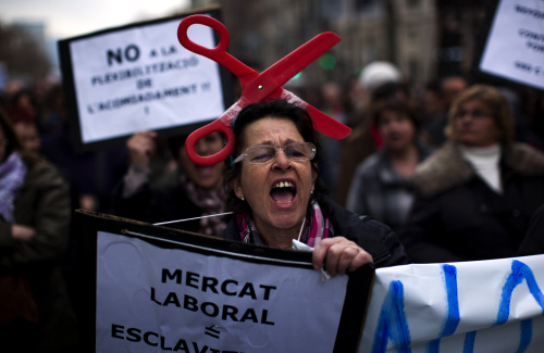 A woman shouts slogans against the government's recently approved labor reforms during a demonstration in Barcelona, Spain, Sunday Feb. 19, 2012. (AP)