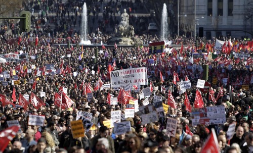 Thousands of demonstrators hold banners against the government's recently approved labor reforms during a protest in Madrid, Spain, Friday Feb. 19, 2012. (AP)