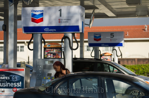 A customer pumps gasoline at a Chevron Corp. gas station in Berkeley, California. (Bloomberg)