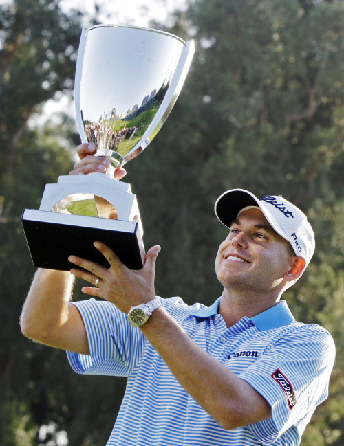 Bill Haas celebrates with the winner’s trophy on Sunday. (AP-Yonhap News)