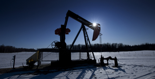 A pumpjack pumps oil from a well on a farmer's frozen field in a Pembina oil field near Pigeon Lake, Alberta, Canada. (Bloomberg)