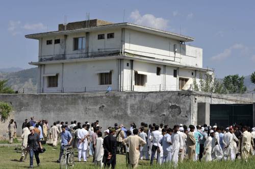 In this photograph taken on May 3, 2011, Pakistani media personnel and local residents gather outside the hideout of Al-Qaeda leader Osama bin Laden in Abbottabad following his death in a US Special Forces ground operation. (AFP)