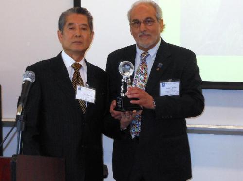 Southern California Sister Cities president Frank Tripicchio (right) gives an award to Sam Han for his humanitarian work. (Southern California Sister Cities)